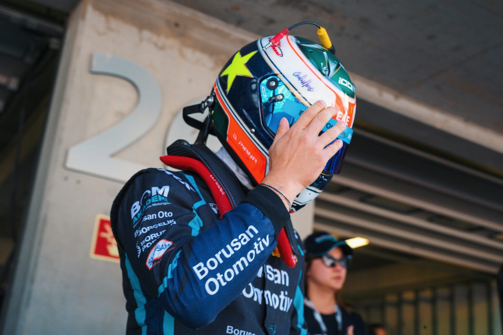 Driver putting on his helmet in the pit lane